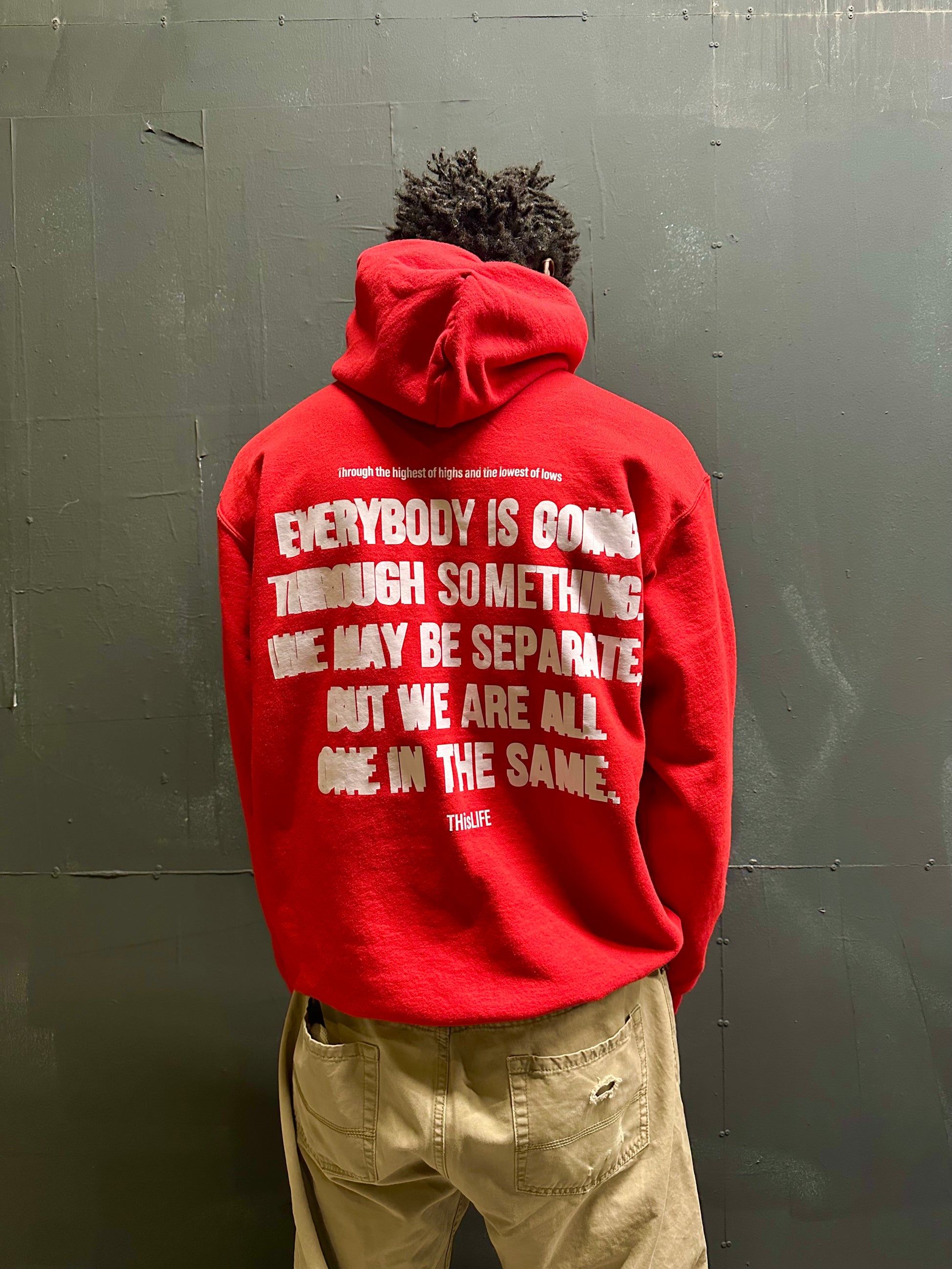 man wearing red champion pullover hoodie with THisLIFE Worldwide design
